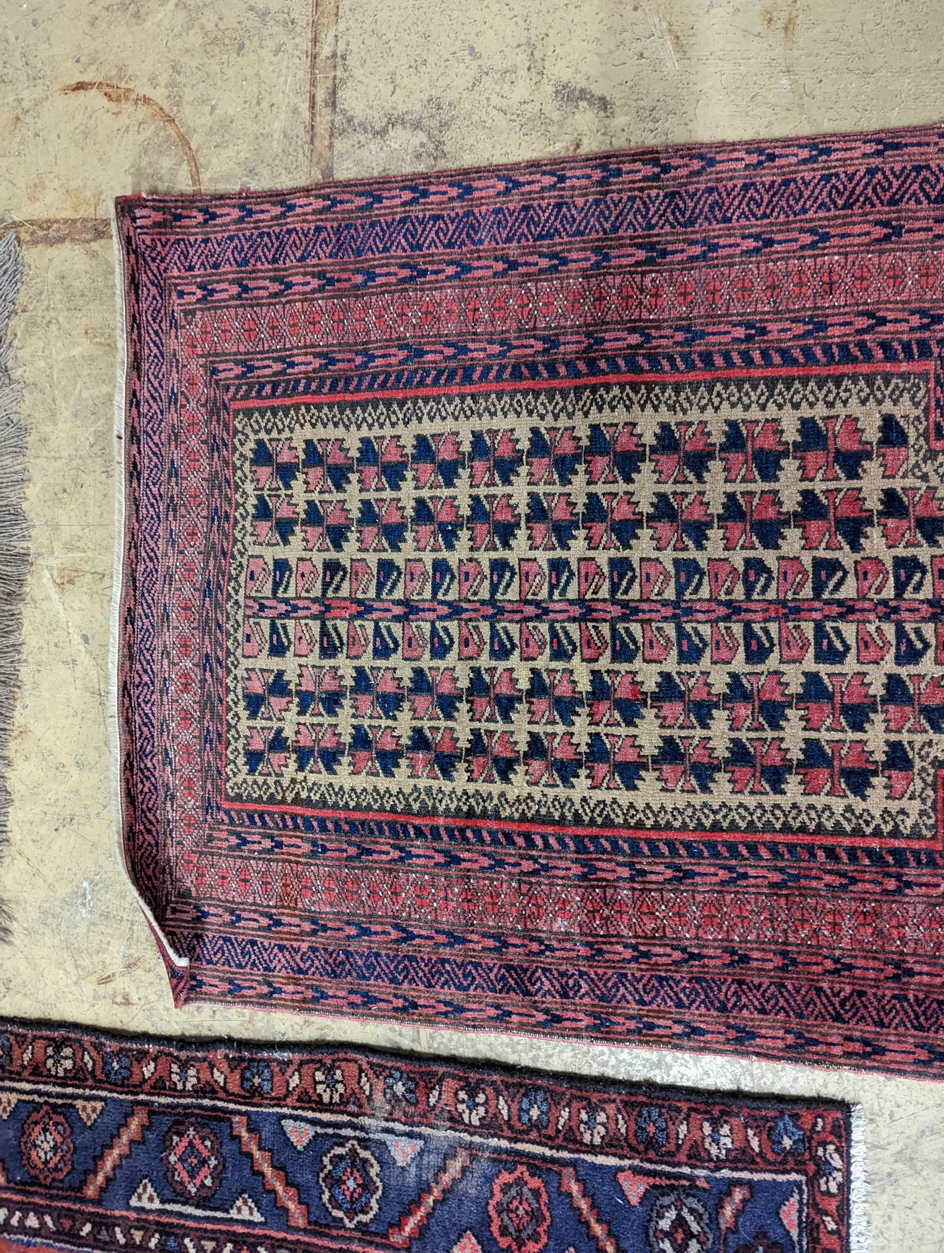 A Bokhara red ground rug and a Belouch prayer rug, larger 144 x 88cm
